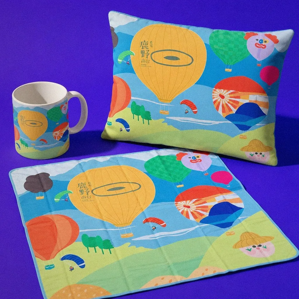 Luye Highland hot air balloon graphic applications on display: picnic mat, cushion, mug | Howdy Creative