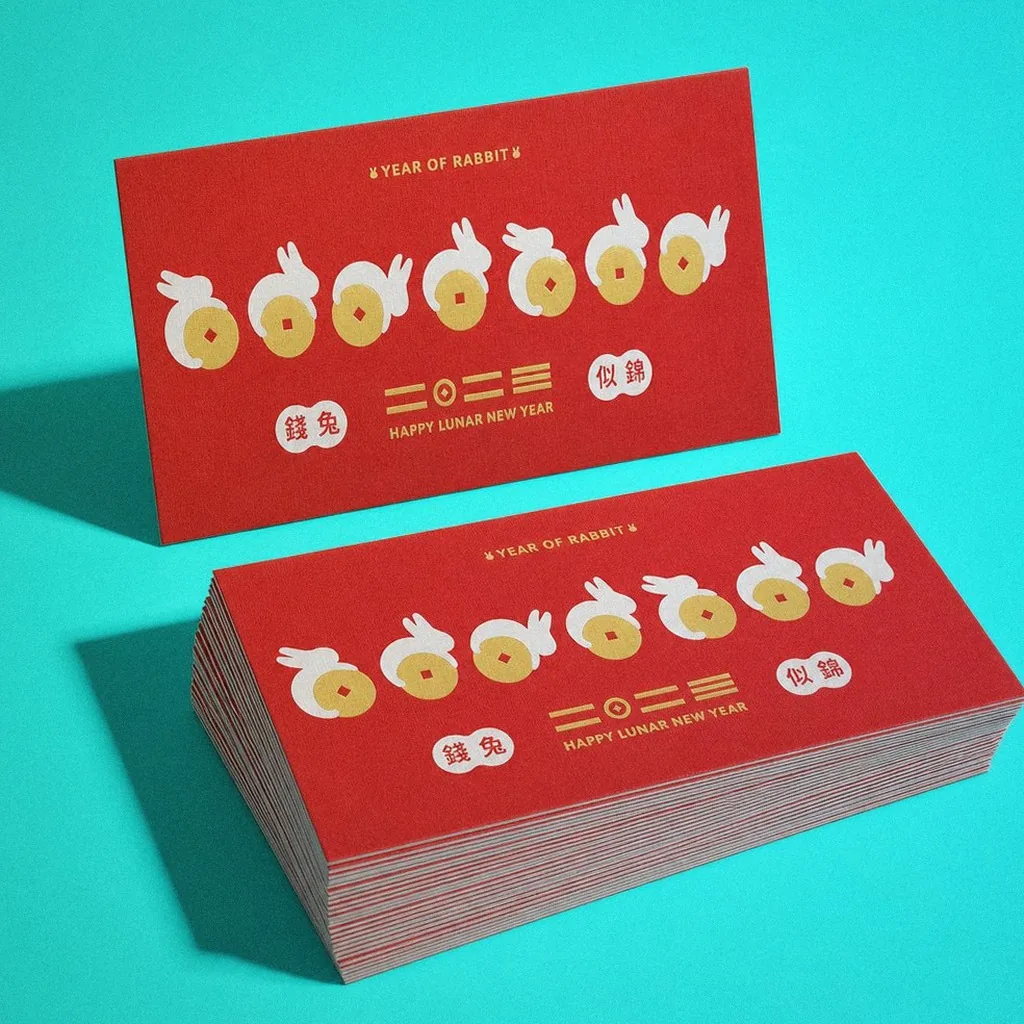 Foil-stamped Year of the Rabbit red packet display, cards and a full stack of envelopes | Howdy Creative
